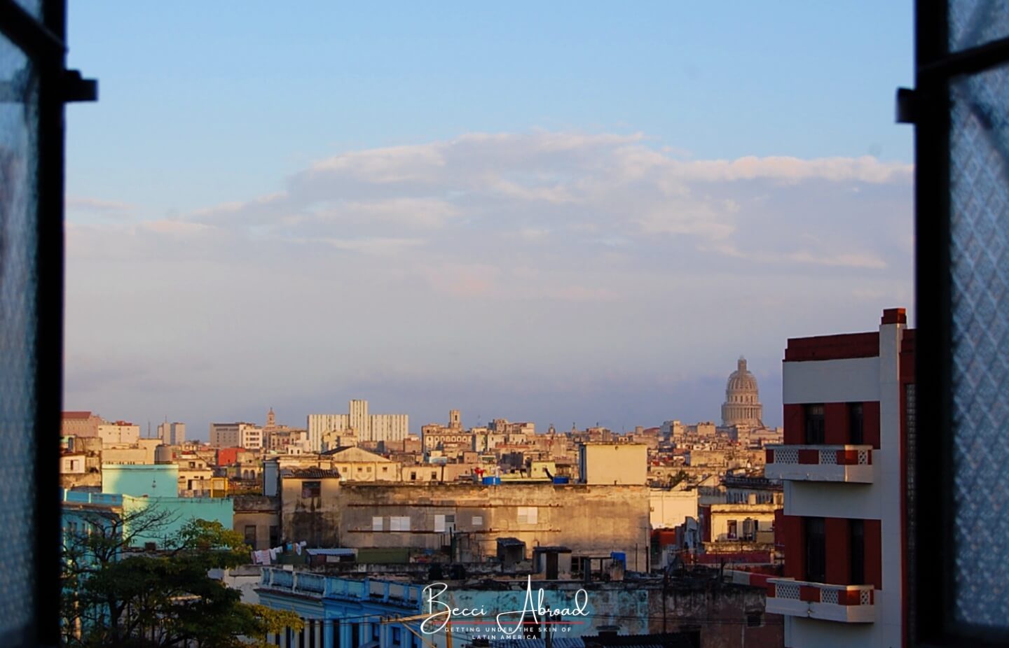 An open window in a casa particular with Havana skyline - one of the best things to do in Cuba for first-timers.