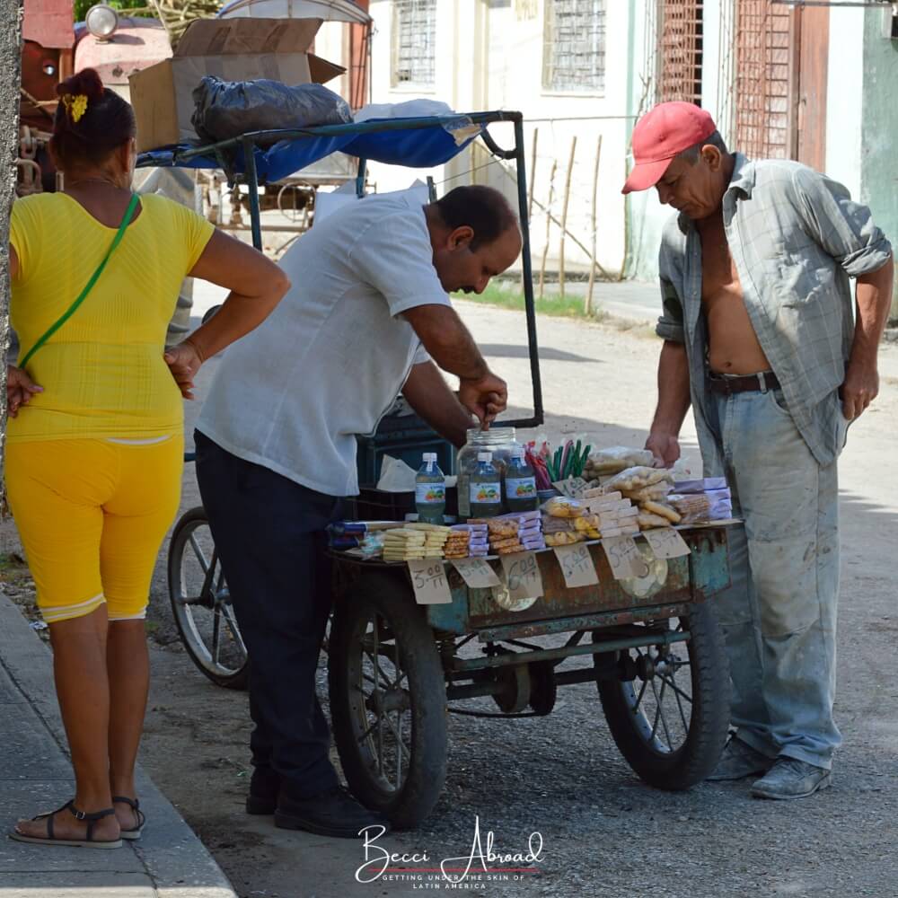 A street vendor in Cuba selling to a Cuban man