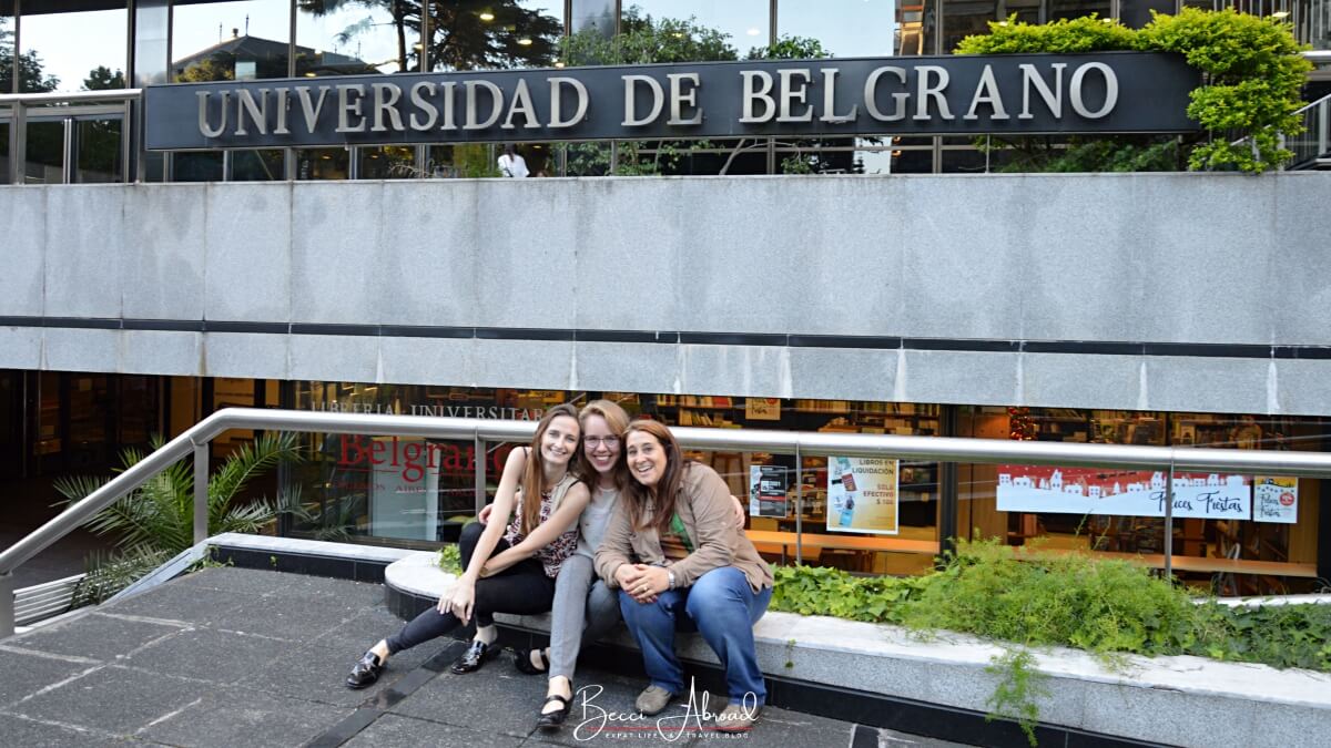 Group of students sitting outside Universidad de Belgrano after their last exams