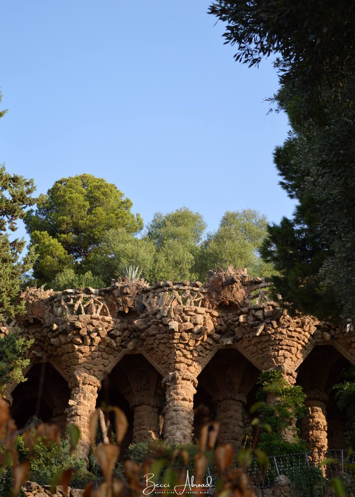 How to visit Park Güell: Take a stroll through the park’s viaducts, which provide scenic walkways supported by stone pillars designed by Gaudí.