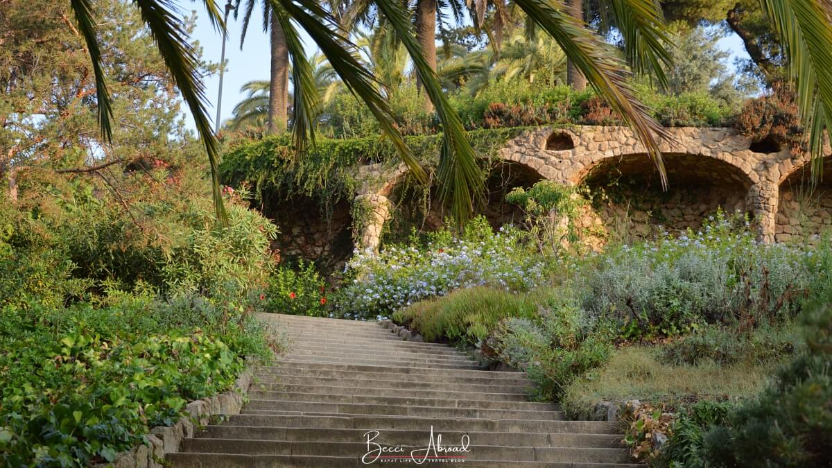 Things to do in Park Güell: Walking through the Austria Gardens, a peaceful section of the park filled with native plants and trees.