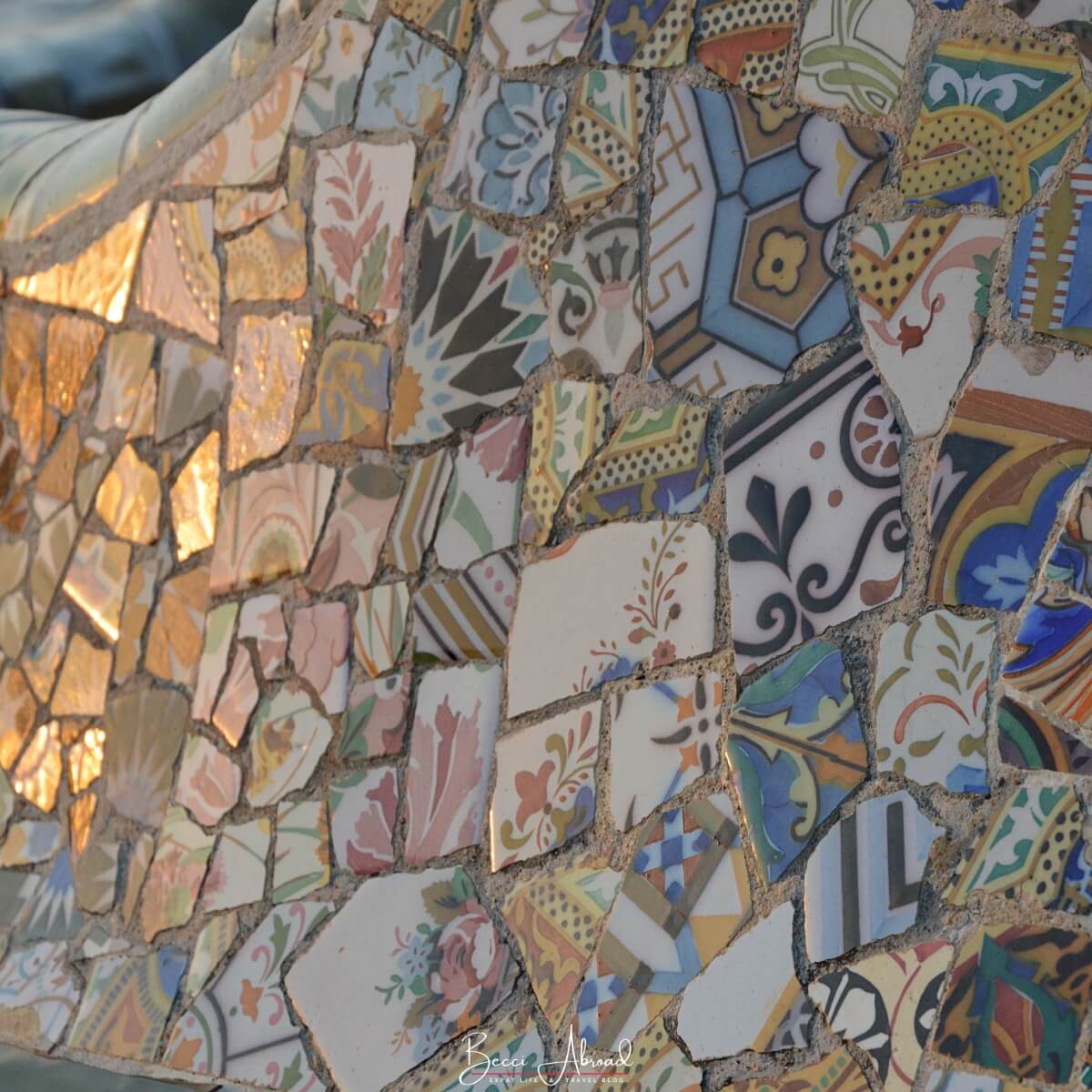 A close-up of the trencadís mosaics decorating Gaudí’s serpentine bench