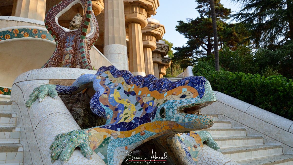 The iconic lizard sculpture known as "El Drac" in Park Güell in Barcelona, a popular photo spot for visitors to the park.