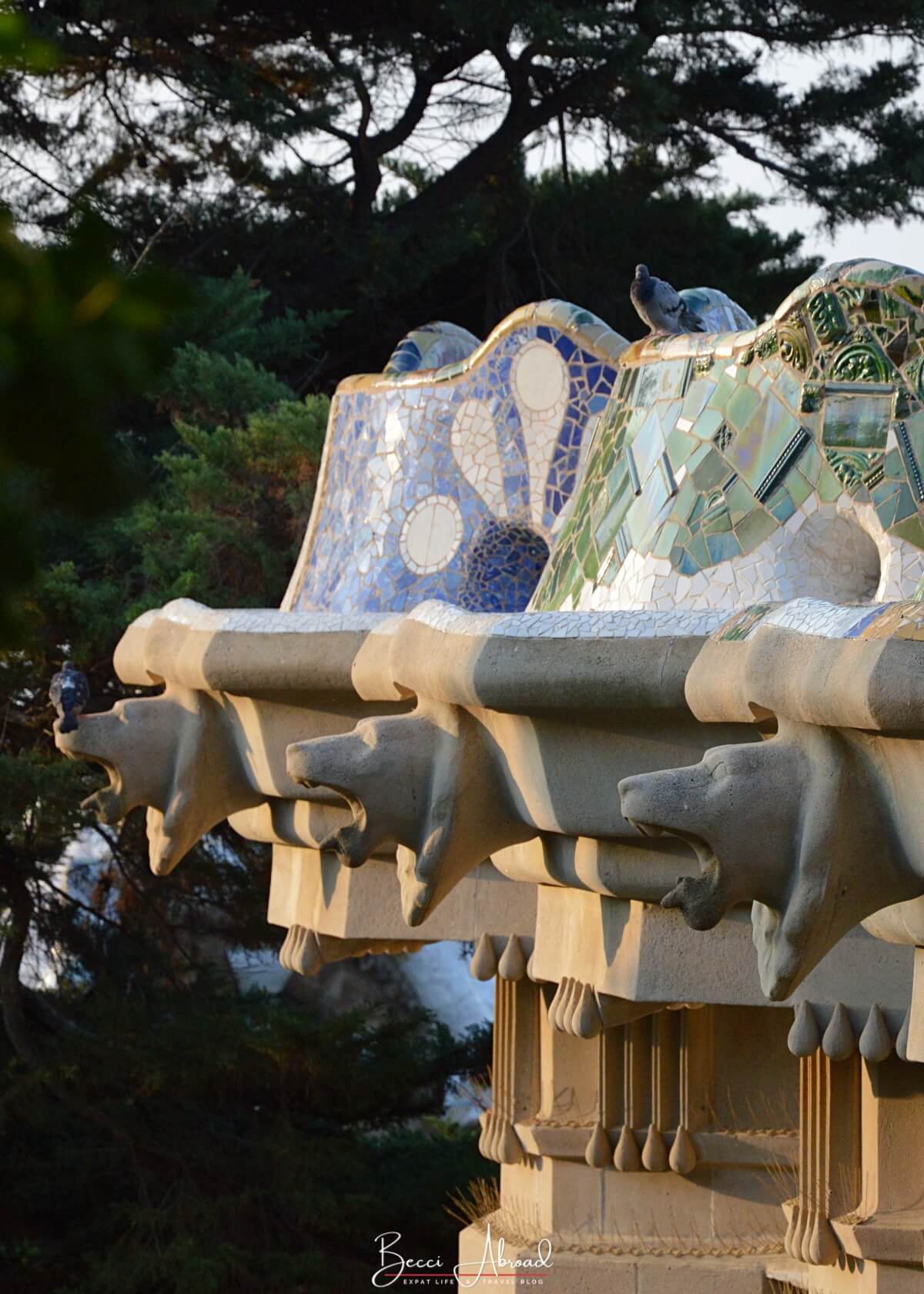 A close-up of the serpentine mosaic bench in Park Güell, wrapping around the edge of the upper plaza with views over Barcelona.