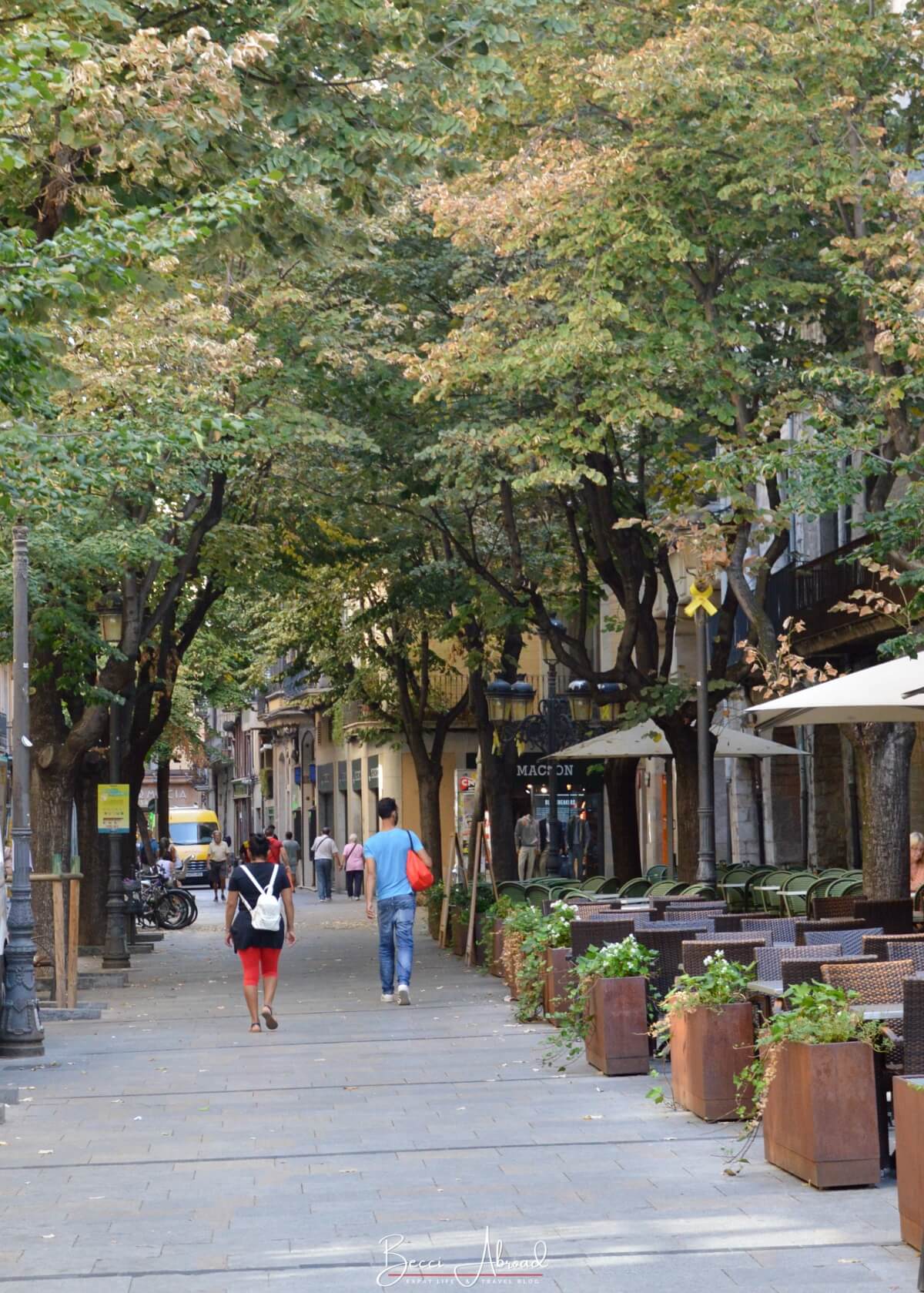 Walking along the stone-paved Rambla de la Llibertat in Girona