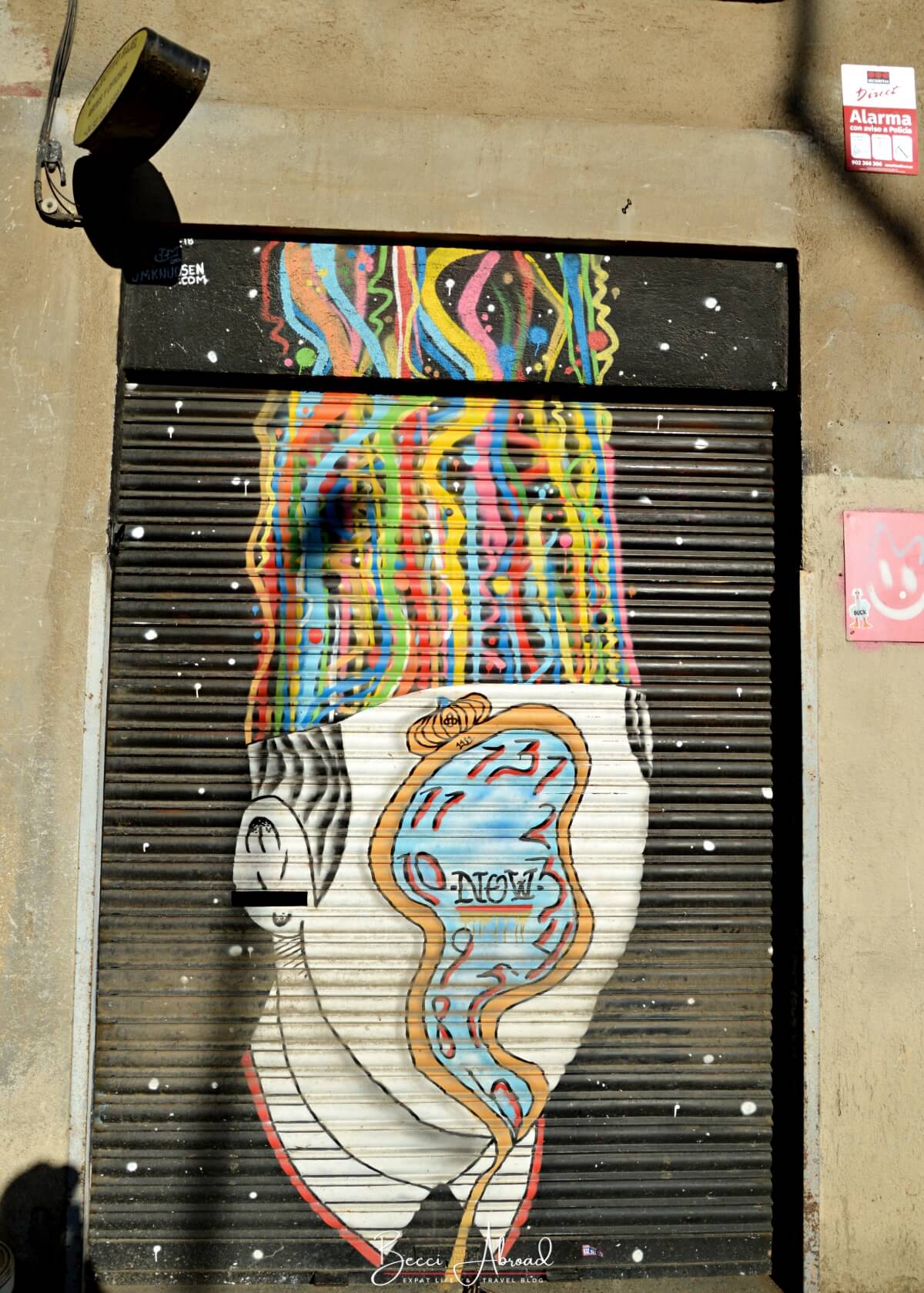 Street art mural of a head made of a colorful watch 