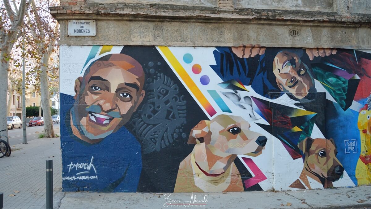 Colorful street art in Poblenou Barcelona with a man and two dogs