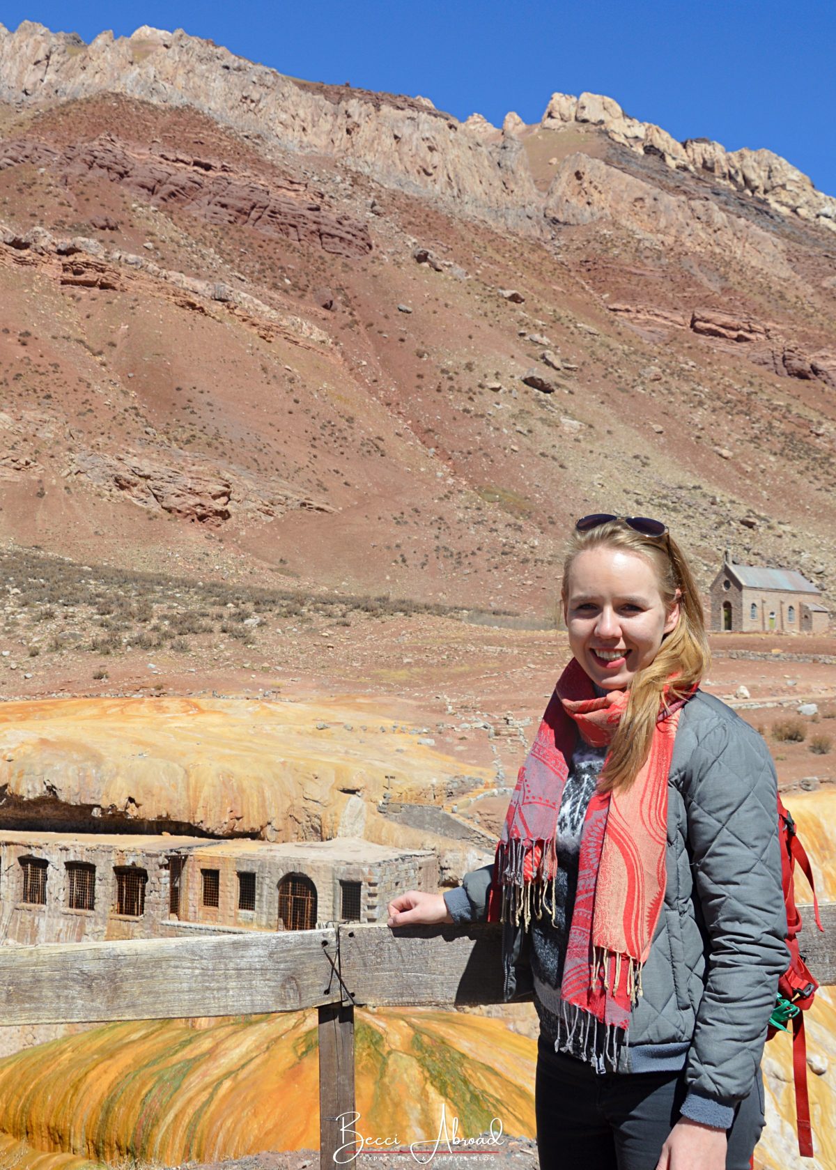 Tourists by Puente del Inca, a natural stone bridge with hot spring formations.