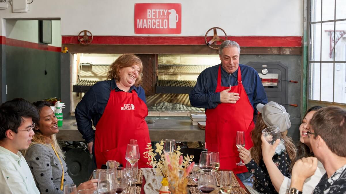 Betty & Marcelo chatting with guests at their traditional barbecue experience in Buenos Aires