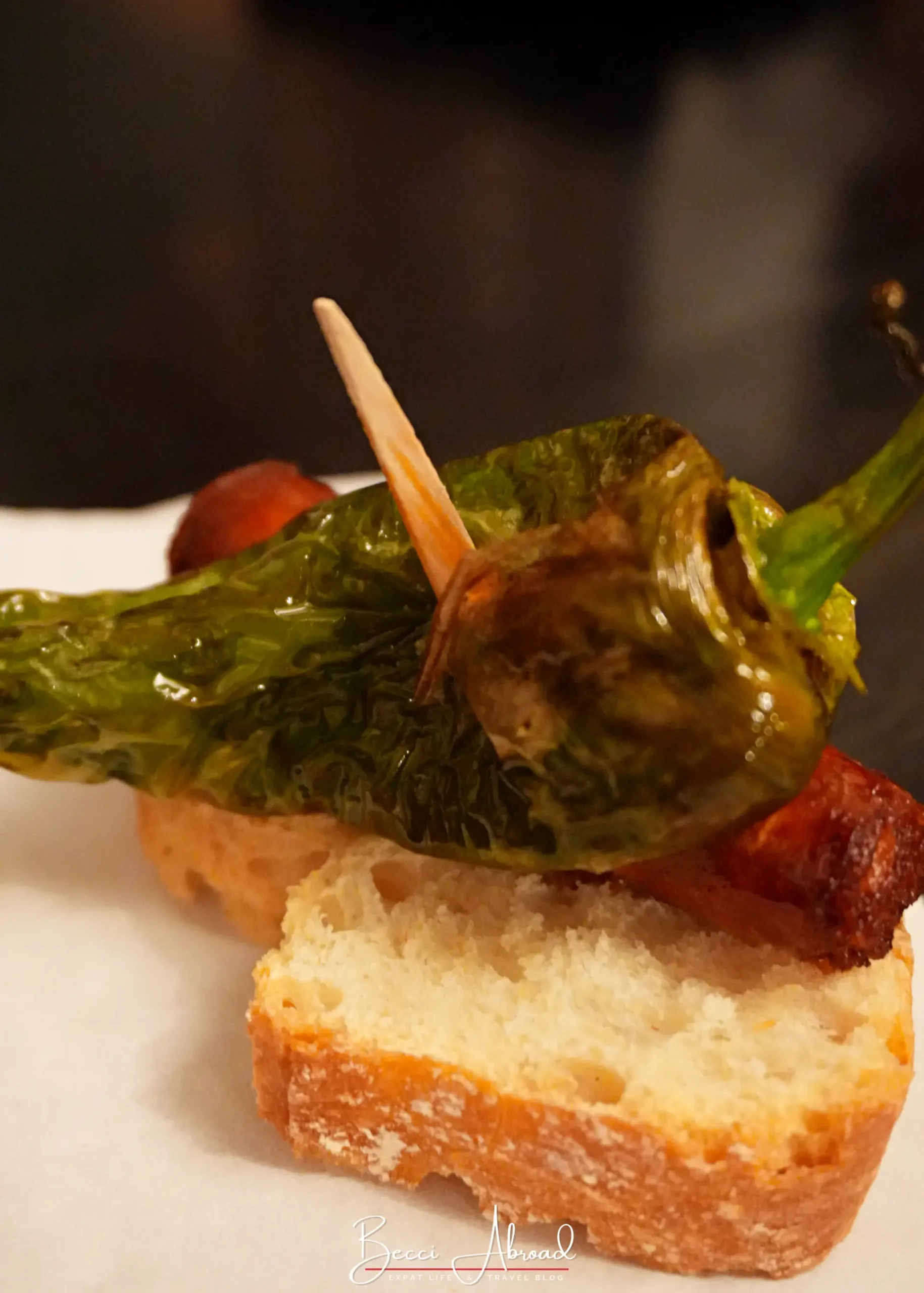 Pintxo tapas with chorizo sausage and pimiento de padrón