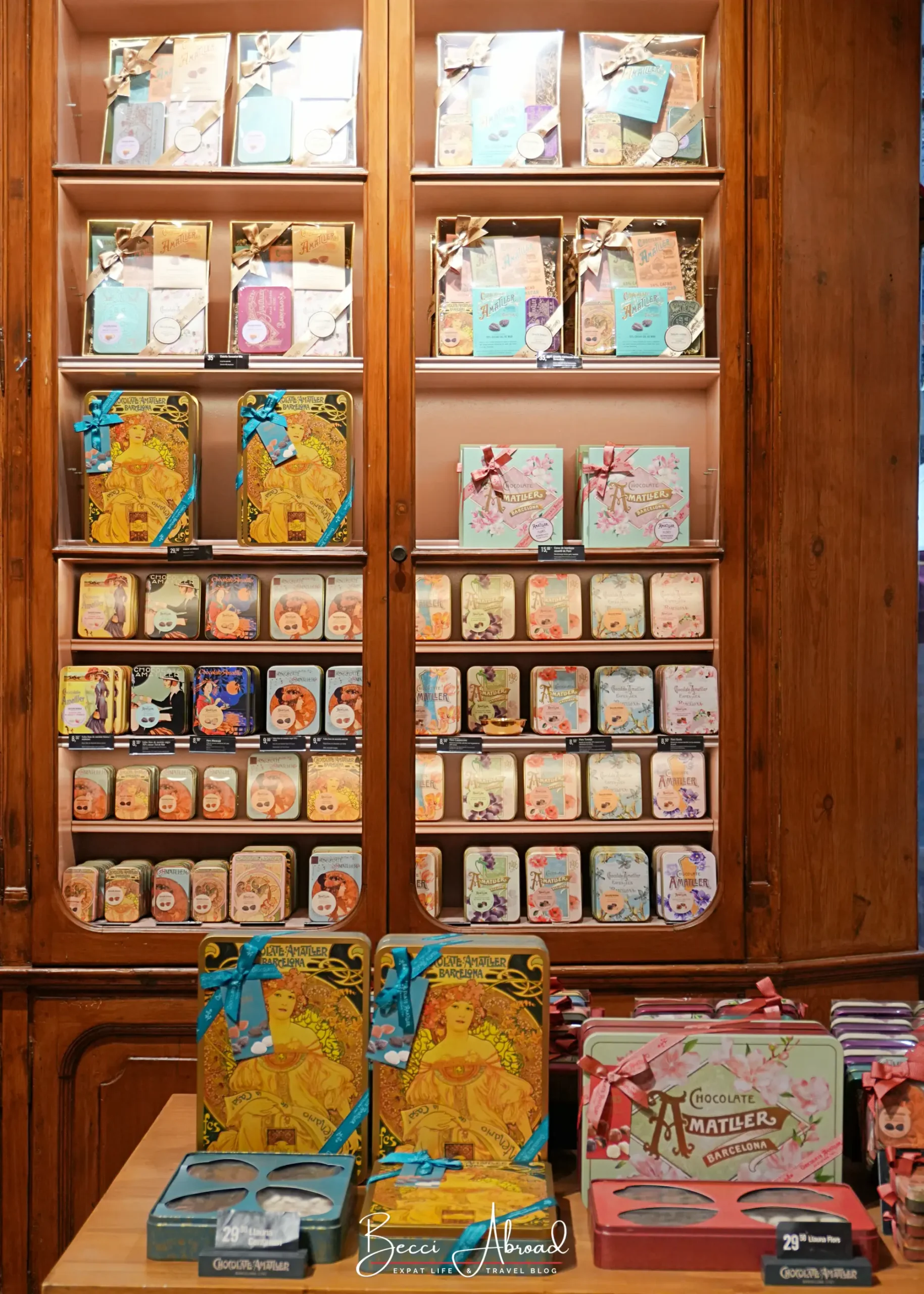 Chocolate Amatller chocolate bars and gift boxes on wooden shelves in the store
