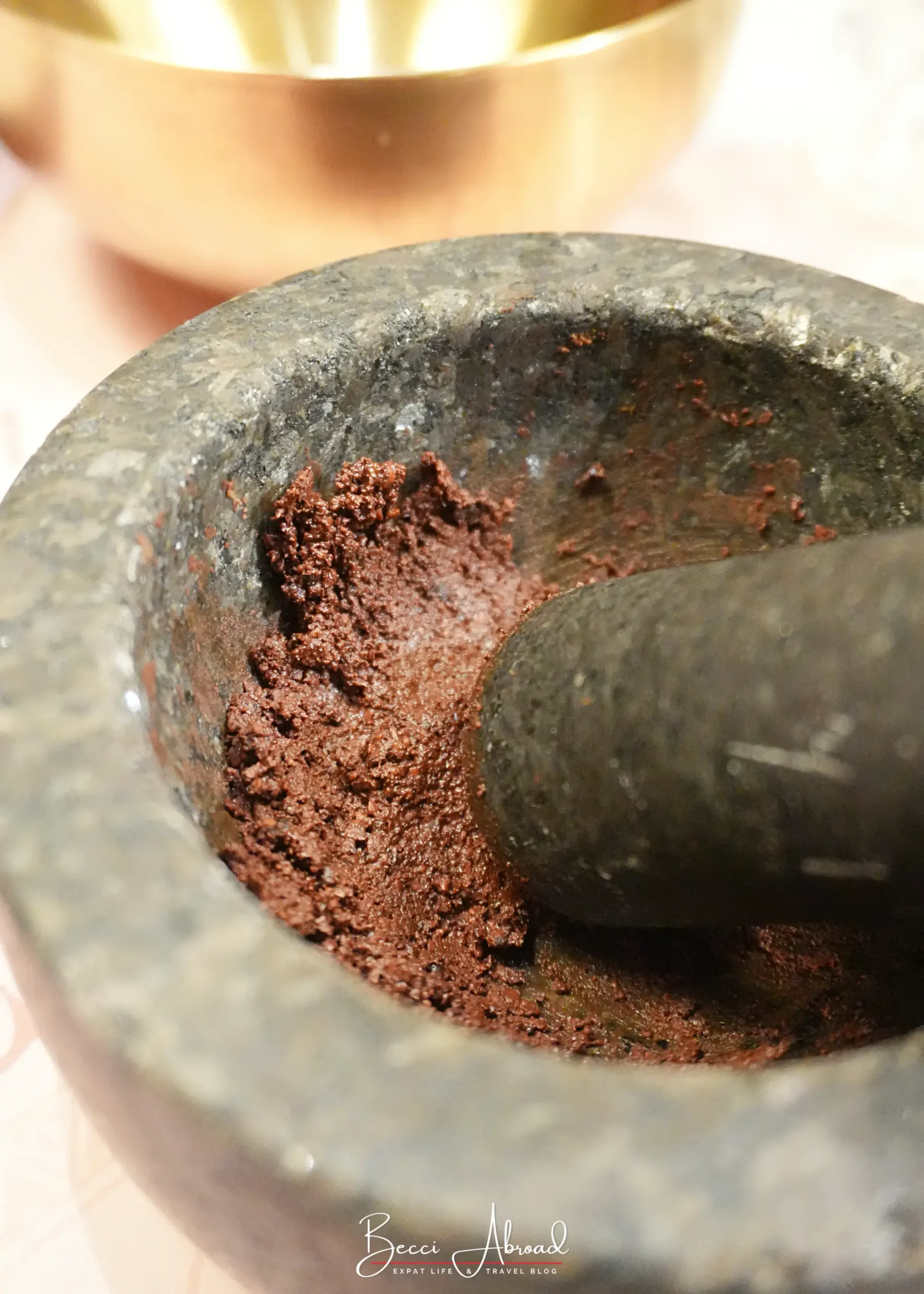 Mashing cacao beans into chocolate paste at the Chocolate Amatller workshop